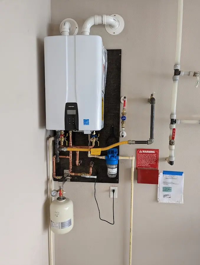 Professional plumber installing copper piping in a Superior home